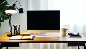 The computer in the office is a sleek modern desktop setup you see the back of the computer not the screen positioned on a spacious wooden desk clutte-1